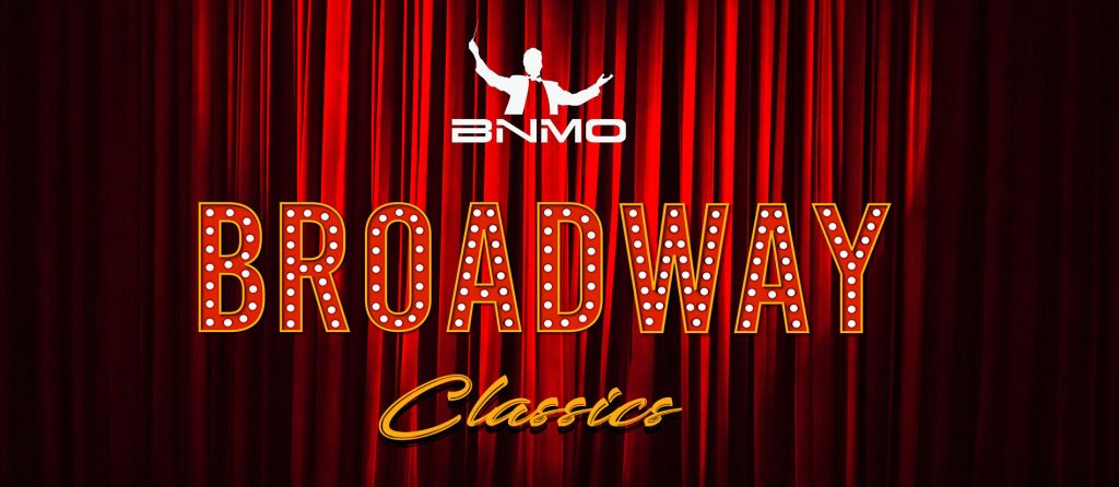 BNMO Broadway Classics in bright lights against a red velvet stage curtain